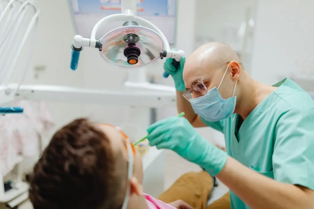 Dentist performing oral examination to detect dental issues.