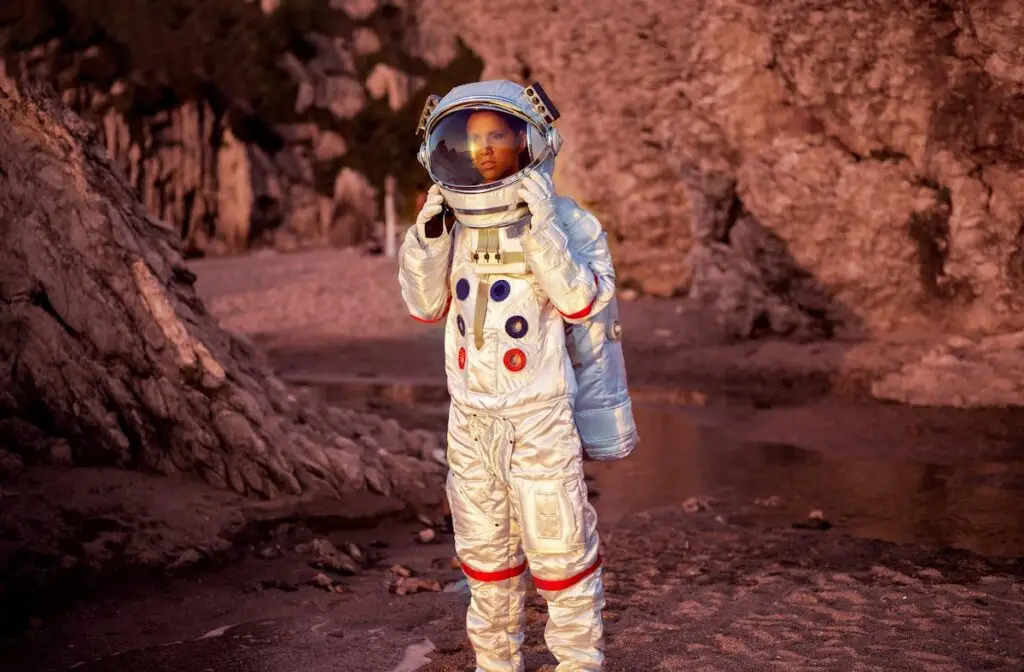 Astronaut in a space suit exploring the Martian surface under a red sky, symbolizing future space colonization and healthcare challenges.