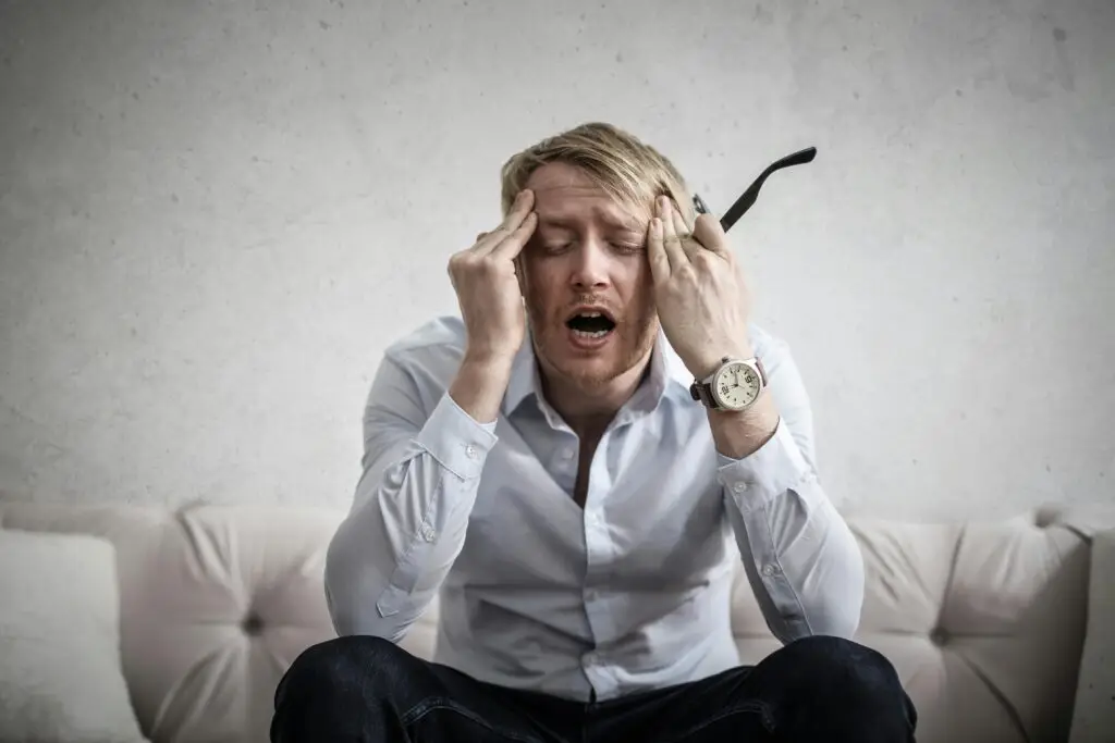 Man in pain due to temporomandibular joint disorder or severe dental issues.