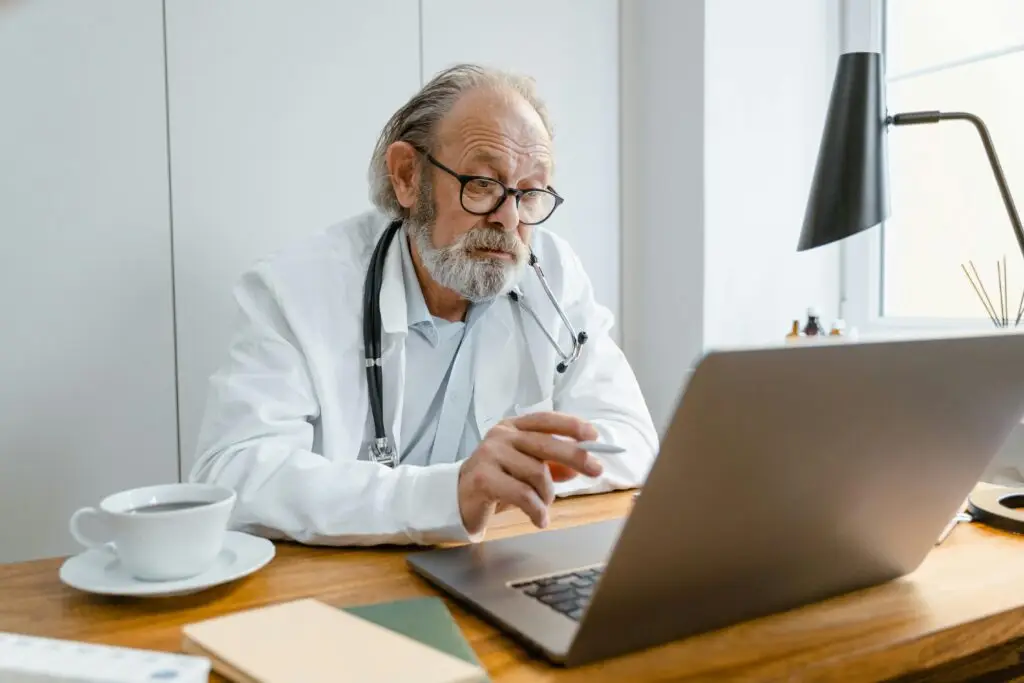Senior doctor providing virtual consultation through video call
