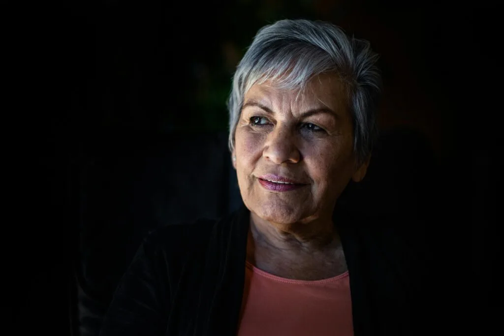 Older woman with facial sagging from Wegovy weight loss, affecting oral health appearance.