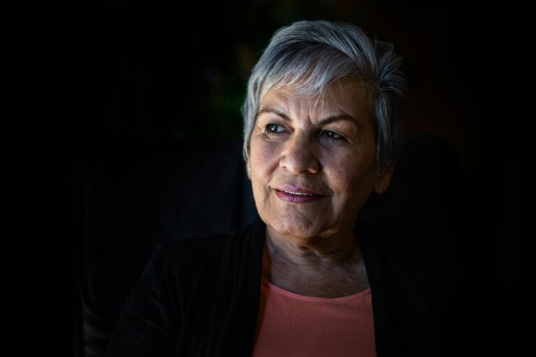 Older woman with facial sagging from Wegovy weight loss, affecting oral health appearance.