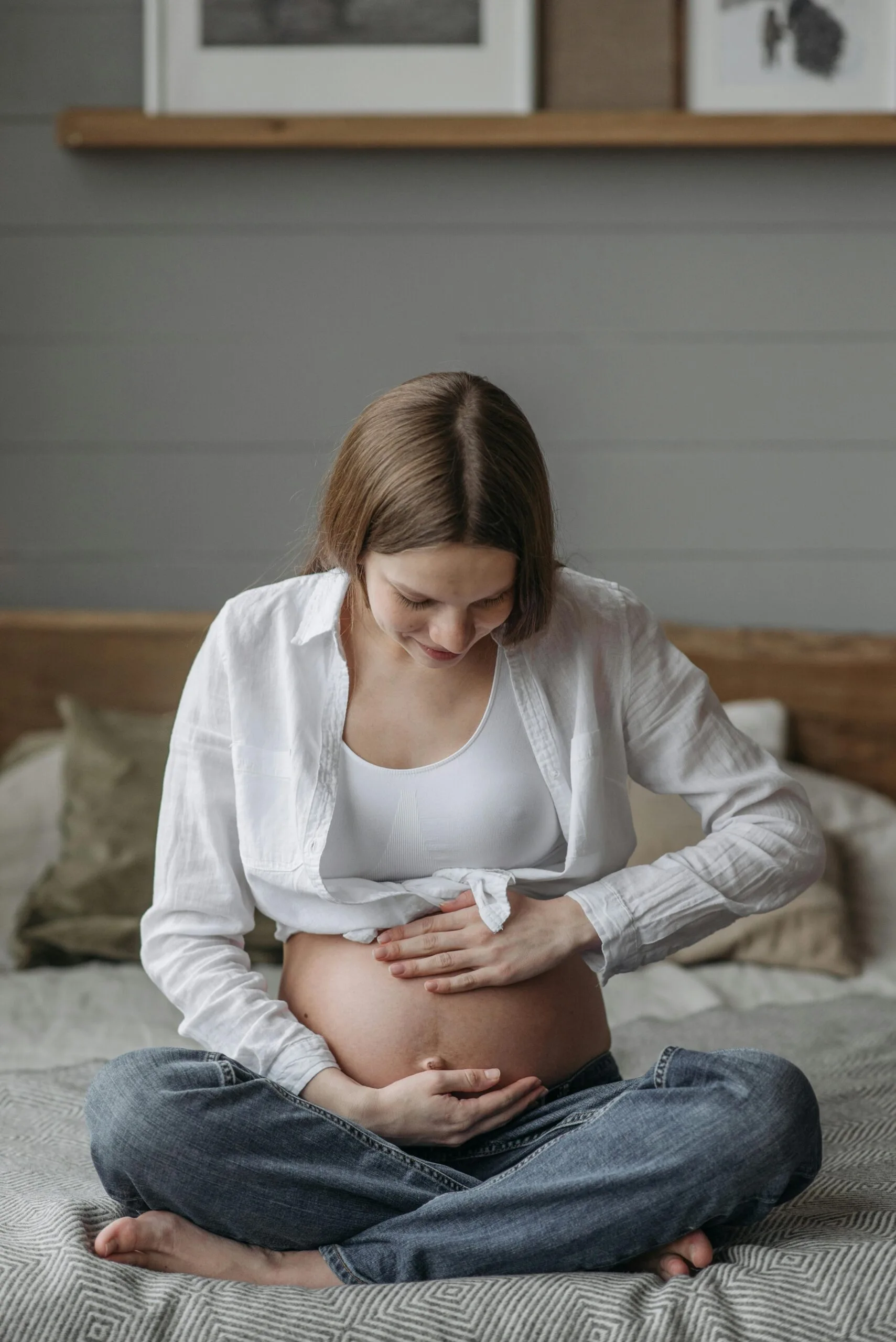 a pregnant woman sitting on the floor.